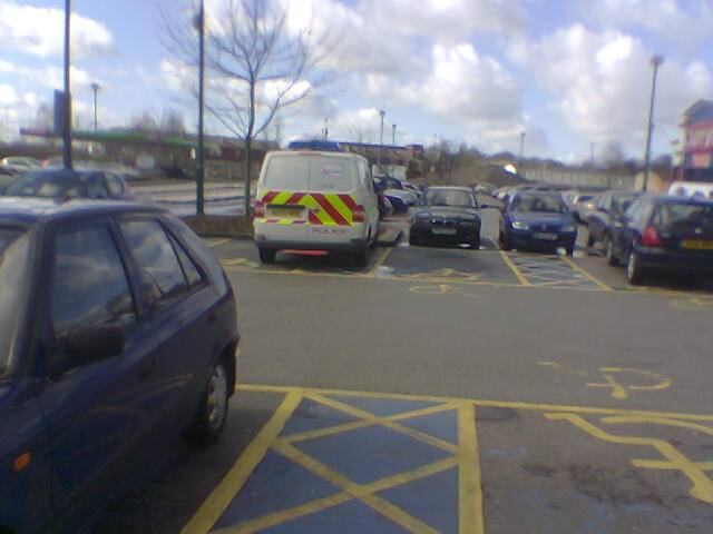 Police van parked in disabled parking bay at ASDA supermarket