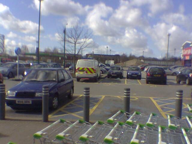 Police van parked in disabled parking bay at ASDA, supermarket