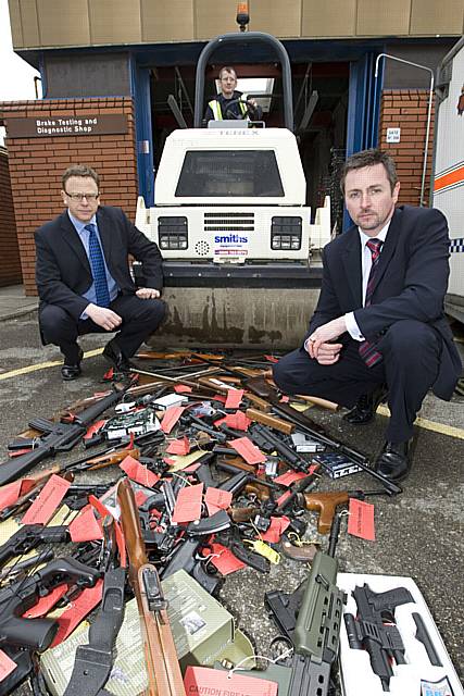Trading standards officer Graeme Levy and DCI John Lyons with imitation firearms