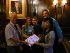 European summer campers present President Norman Wellens with a banner commemorating their visit to Middleton Rotary.