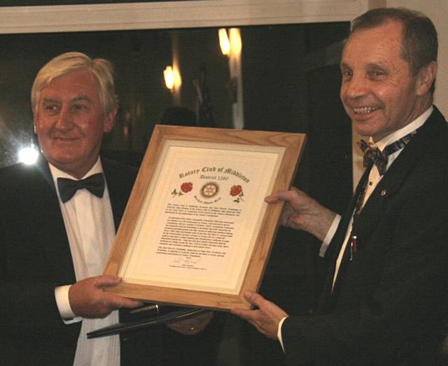 John Brooker (left) receives the prestigious Paul Harris award from Middleton Rotary President Peter Hayward.