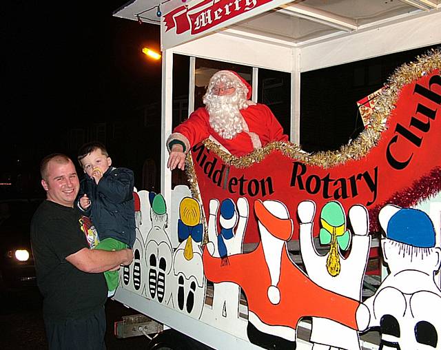 Middleton residents meet Father Christmas as the Rotary Club of Middleton's festive float tours the town in 2009