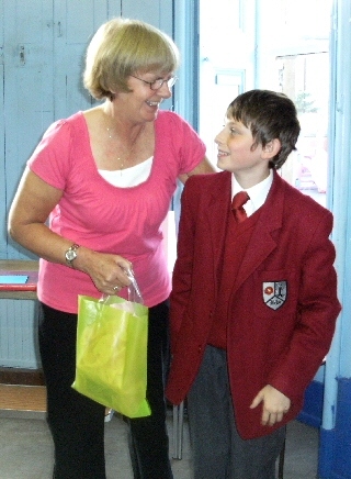 Mrs Mills receives a present from Aston Buckley - a former pupil of Glebe House and currently attending Beech House