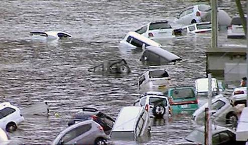 In this image from Japan’s NHK TV video footage, vehicles are washed away by the tsunami. Picture courtesy Press Association 