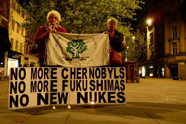 Littleborough residents, Mai Chatham and Rae Street holding the Peace Group banner over a placard reading 'No More Chernobyls. No More Fukushimas. No New Nukes.'