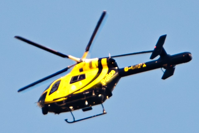 Greater Manchester Police helicopter circling the town centre above the National Front demonstrators