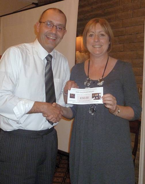 Sue Furby presenting Kit Wellens with his prize donated by The Halfway House, Royton