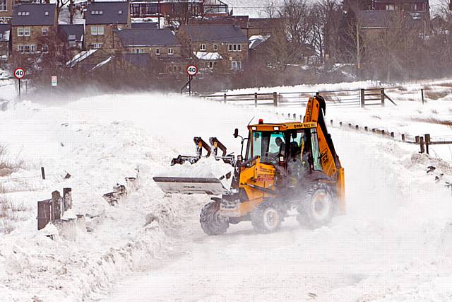 Tractor snow plough, trying to clear a road