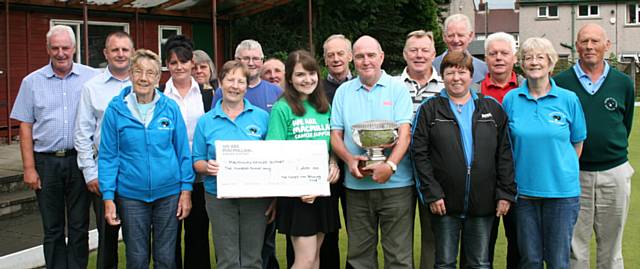 Becca Harnett and the bowling team with the winner, John Nyland (central) at the cheque presentation