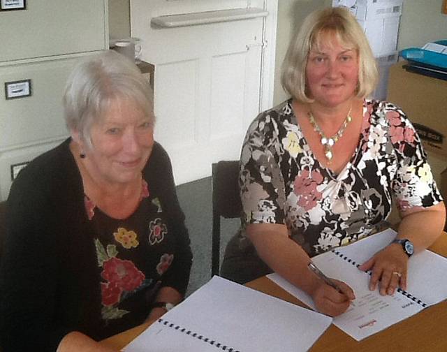 Lynda Robinson Chair of the Petrus Community & Babette Howard, Trustee  Chair of The Bond Board sign the Partnership Agreement