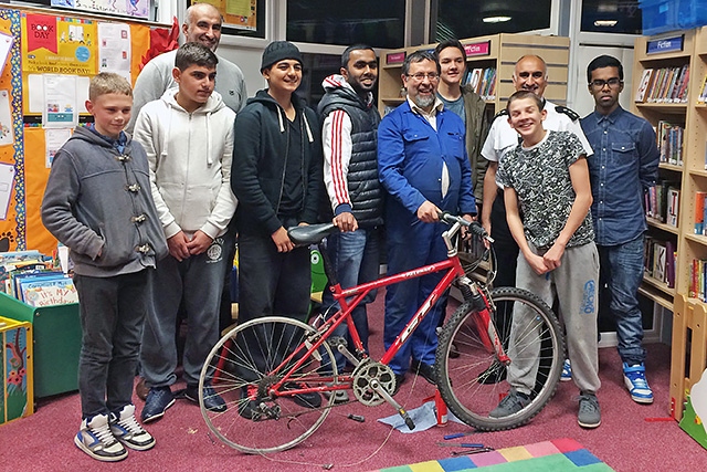 Steve Durham (centre) and Chief Inspector Nadeem Mir with Smallbridge Youth Club members