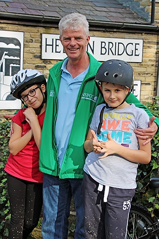 Amelia and Zachary Hill with Grandad Bob Chadwick at the end of the ride in Hebden Bridge