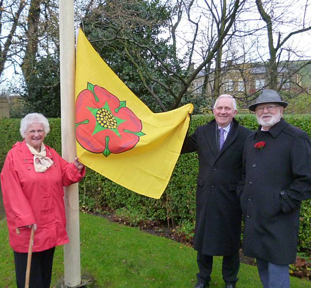 Councillor Ann Stott, Councillor Ashley Dearnley and The Chairman of Leaf, Steve Lister raise the Lancashire Day Flag