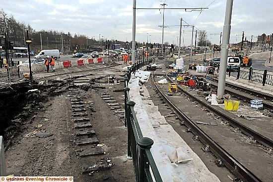 Workmen connecting the Oldham town-centre tracks 
