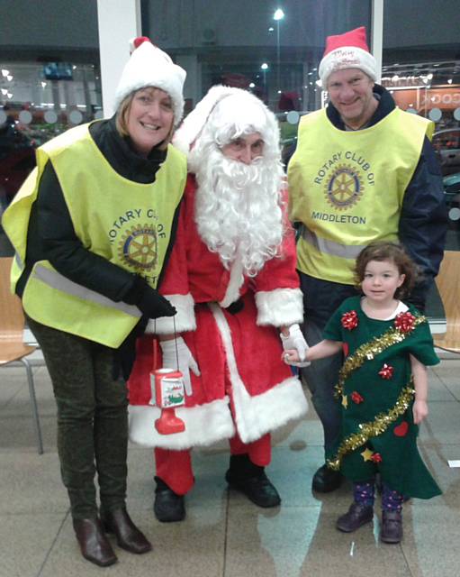 The Rotary Club of Middleton fundraising at Sainsbury with Sue Furby, Father Christmas, Keith Trinnaman and a little helper