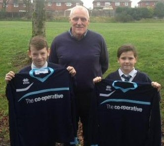 Keith Hicks, Rochdale AFC Football in the Community Trust Manager, with Liam Greenwood and Ella Mooney, who are pupils at Alkrington Primary School