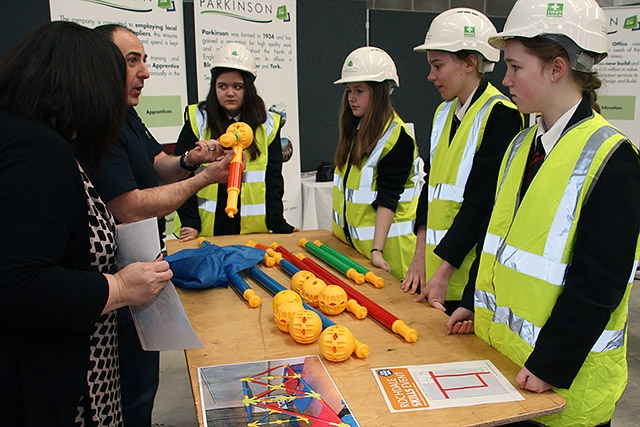 Mike Tyler from F Parkison Ltd explains a task to students from Cardinal Langley