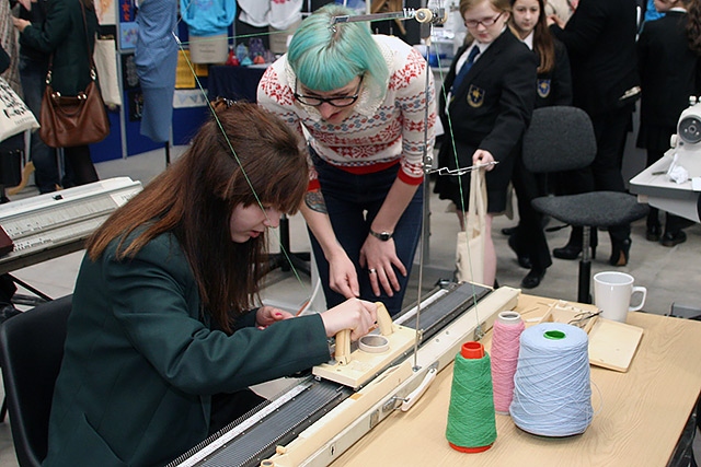 A student involved in a textiles industry demonstration 