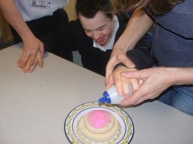 Pupils making a wedding cake 