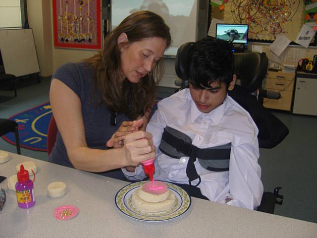 Pupils making a wedding cake