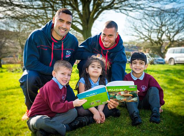 Rochdale Hornets players Sam Teo and Ryan Millard with Whittaker Moss Primary School pupils Harry Dunn, 5, Amina Dar, 6, and Zaci Amid, 5 
