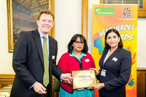 Naila Ilyas being presented with her award by Neil Clitheroe, CEO of ScottishPower and Baroness Verma, Parliamentary Under Secretary of State,  