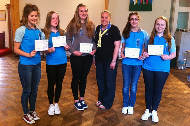 Rebecca Denham, Hannah Basquill, Mia Beresford Carter, Lauren Powell and Megan Callaghan with their Baden-Powell Challenge awards, presented by District Commissioner Michelle Newell