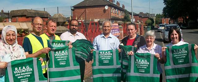 Members of the Rochdale Environmental Action Group with thier new Green Reflective Jackets with the message: R.E.A.G., Volunteer, Love Rochdale  - Hate Litter
