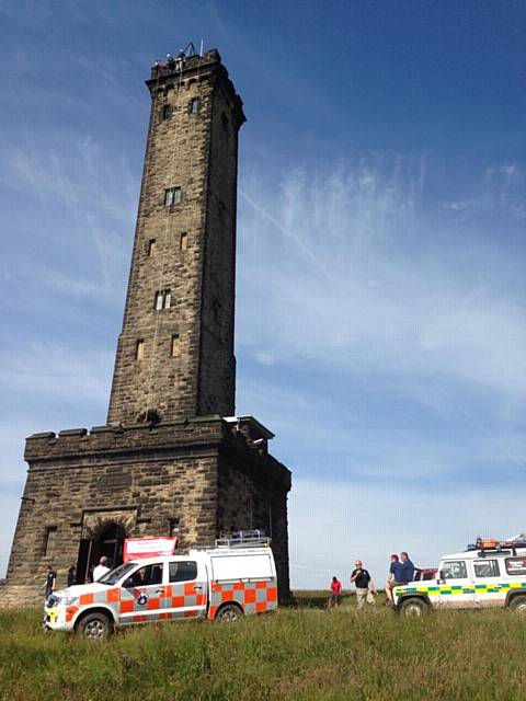 Rossendale and Pendle Mountain Rescue Team brave supporters abseiling down the side of Peel Tower