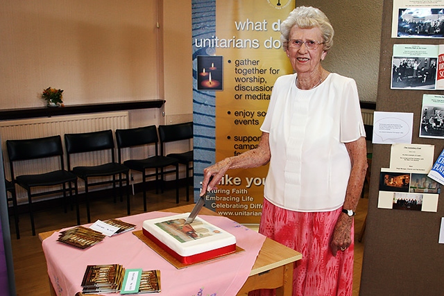 Unitarian Church 40th anniversary - Eunice Smith cutting the anniversary cake