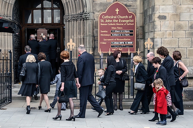 Jim Dobbin's family follow his coffin into Salford Cathedral