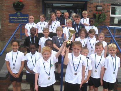 KS2 children with their Cross Country trophy and for individual medals