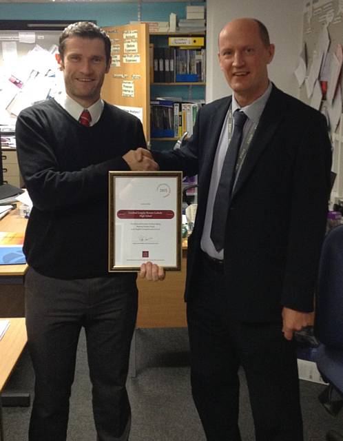 Headteacher, Mr Bridson, presenting the award to Mr Campbell, Head of Sixth Form 