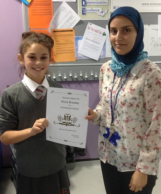 A Brookes awarded outstanding progress certificate from her teacher Miss Sarwar

