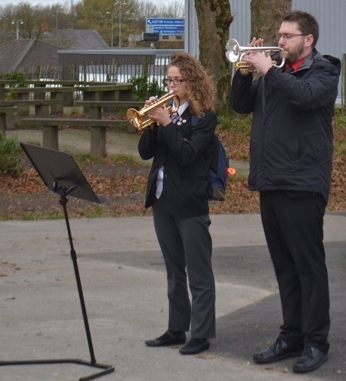 Mr Turner and Y11 student Elisa Iannidinardi in playing The Last Post whilst the school observed a minute silence