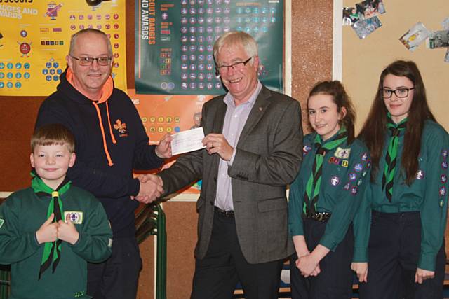 Past President of The Rotary Club of Rochdale East, Len Albon presenting a cheque for £400 to Group Scout Leader, Mike Phillips