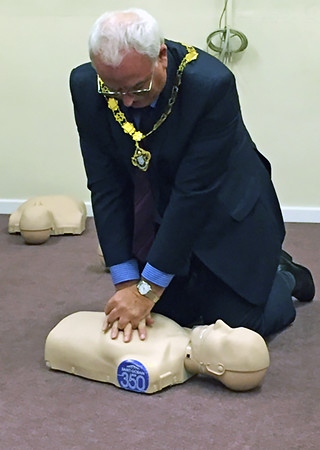 Deputy Mayor Ray Dutton practising CPR at Milnrow Village Practice