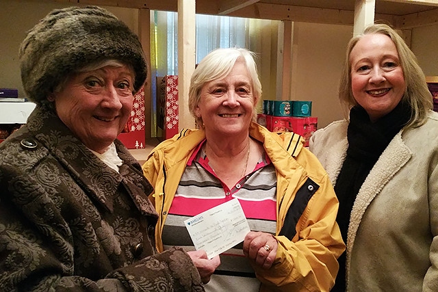Councillor Carol Wardle and Beverley Place hand over a cheque for £1,500 to Christine Downham-Clark of Heywood Foodbank