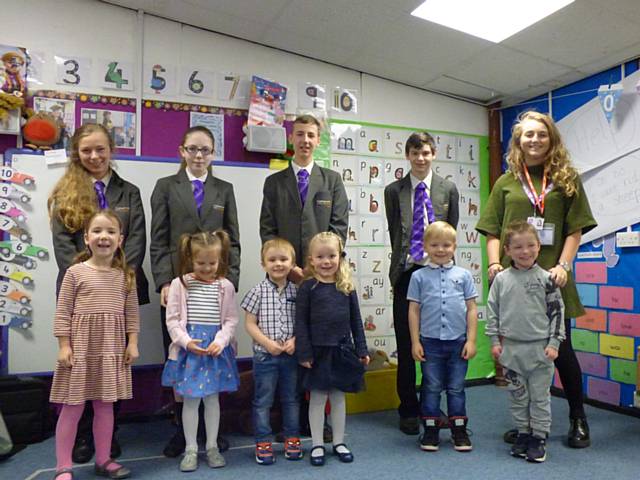 Hollingworth Academy students Emily Russell, 14, Orlaith Harrison Maskew, 15, Robert Green, 14, James Sefton, 14, and Teens and Toddlers programme assistant, Leah Pendlebury, with pupils from Crossgates Primary School in Milnrow, Rochdale