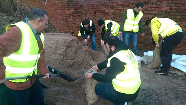Syrian refugees helping with flood prevention efforts in Littleborough