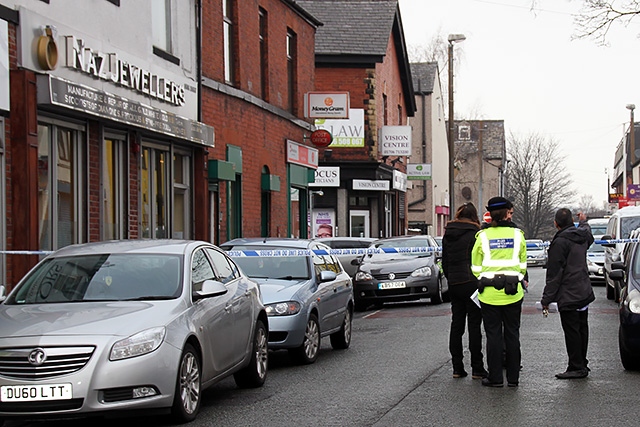 Police cordon off Milkstone Road after the armed robbery at Naz Jewellers