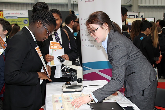 Student speaks to a Source BioScience representative about careers in science a the Rochdale Skills Event