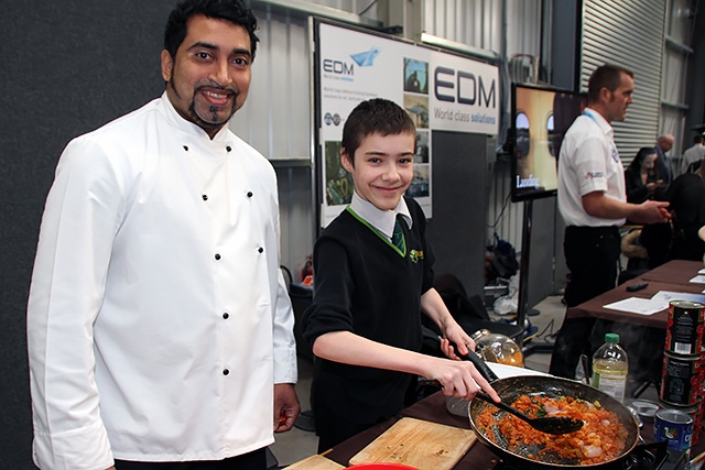 Farooq Ahmed teaches a student to cook at the Rochdale Skills Event
