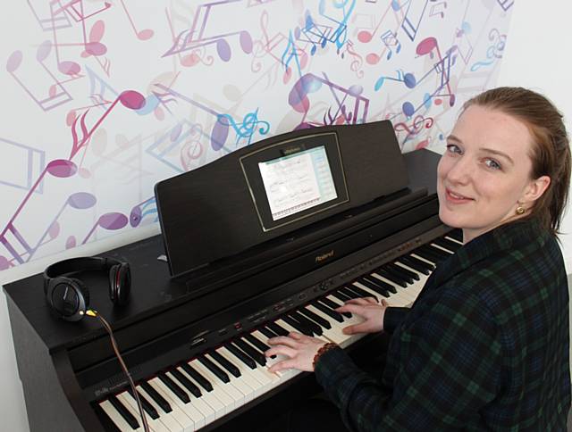 Sarah Barron plays the new digital piano at Rochdale Central Library