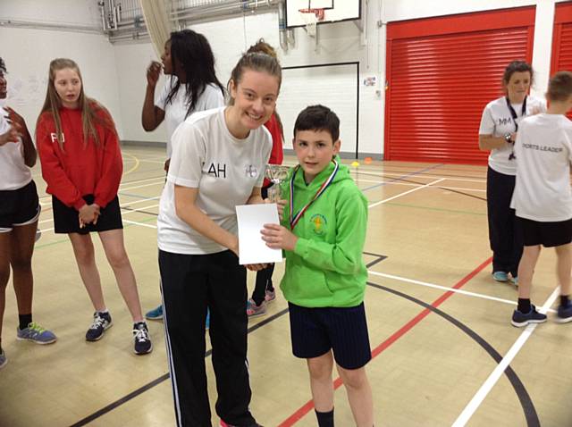 Captain Joshua Smith from St Patrick’s receiving his trophy from Miss Howarth