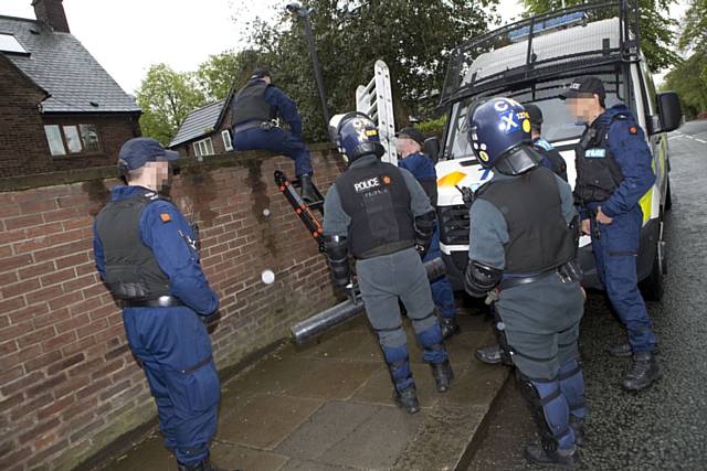 Man and woman arrested after warrants executed by Greater Manchester Police and the National Illegal Money Lending Team