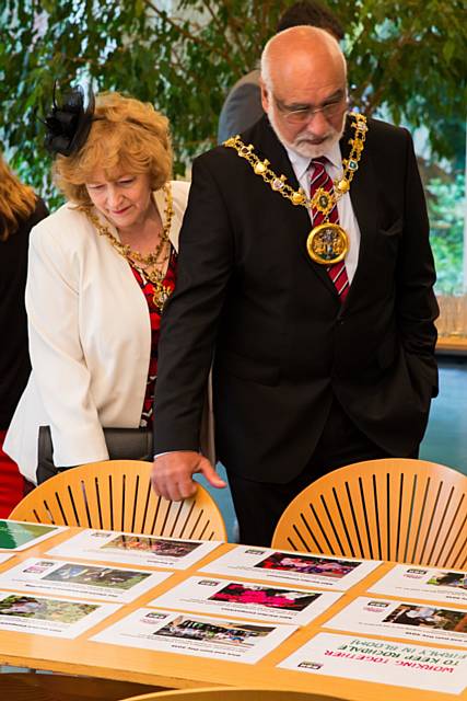 The Mayor and Mayoress take a look at photos of the ground work taken place to prepare Zen’s HQ for the visit