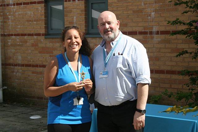 Principal Derek O'Toole presenting the College’s Learning Participation Officer Farah Rehman with the trophy for winning the obstacle course 