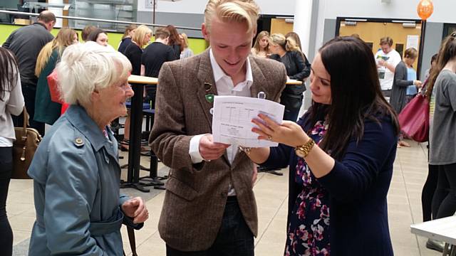 Anthony Kirven opening his results with a teacher and his grandma