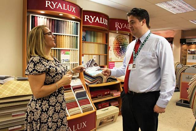 Cllr Blundell tells Sue Williams, Manager of Carpet Creations in Milnrow, how to tap into the fund